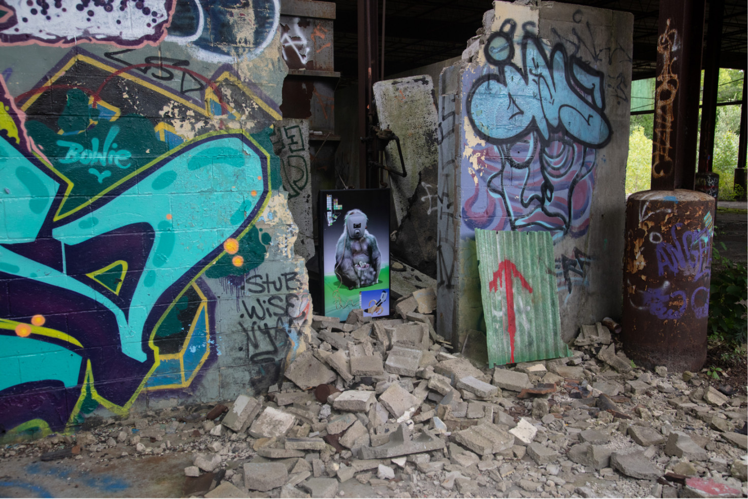A screen showing an animated gorilla rests in the rubble of a graffiti-covered ruin