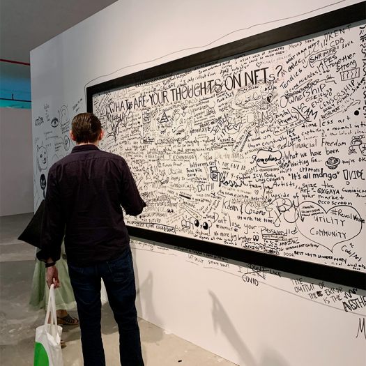 A reads text in black marker on a canvas mural