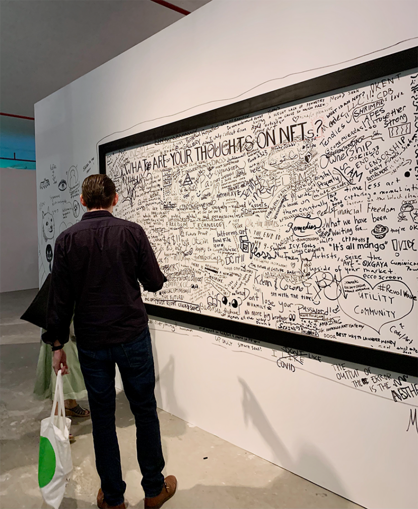 A reads text in black marker on a canvas mural