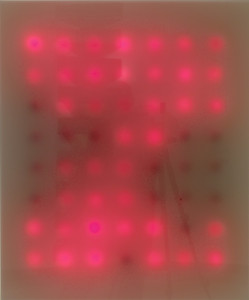 A grid of illuminated red light bulbs behind a translucent panel