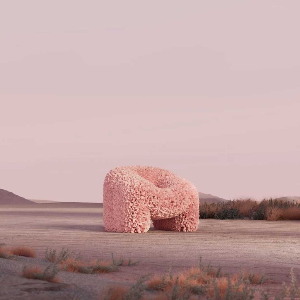 A digital image of a low armchair coated with pink petals standing amid a desert landscape under a pale violet sky