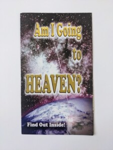 A photograph of a religious pamphlet with an image of the Earth below a galaxy of glowing stars